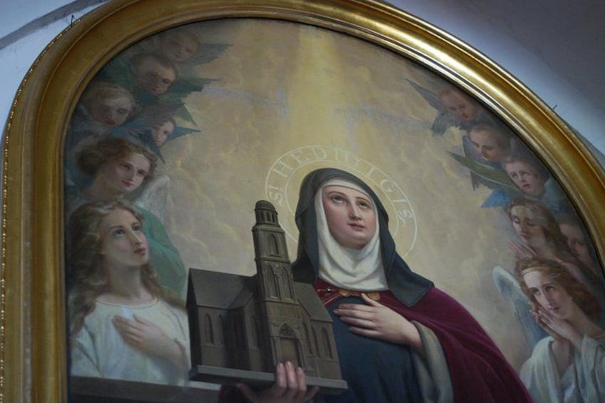 A religious painting with a central figure holding a church model, surrounded by angels. 2