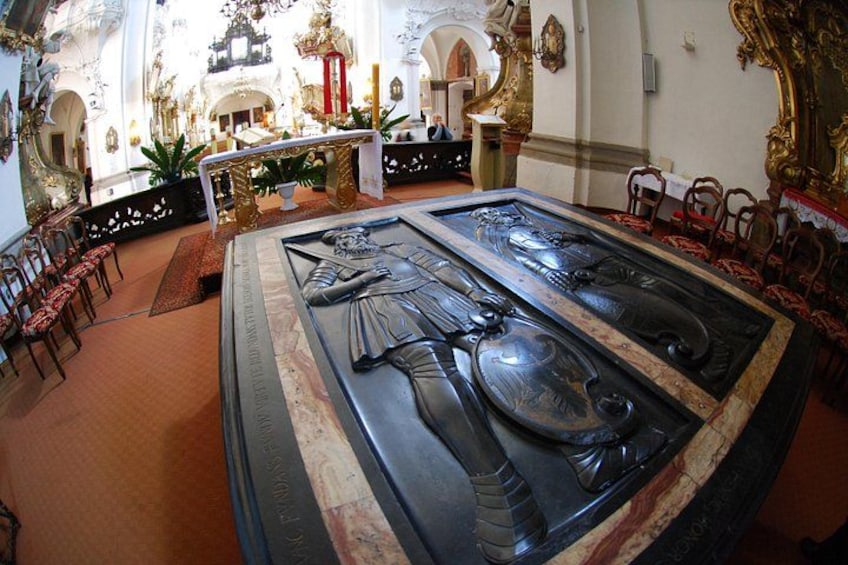 An ornate sarcophagus with intricate carvings in a church interior. 3