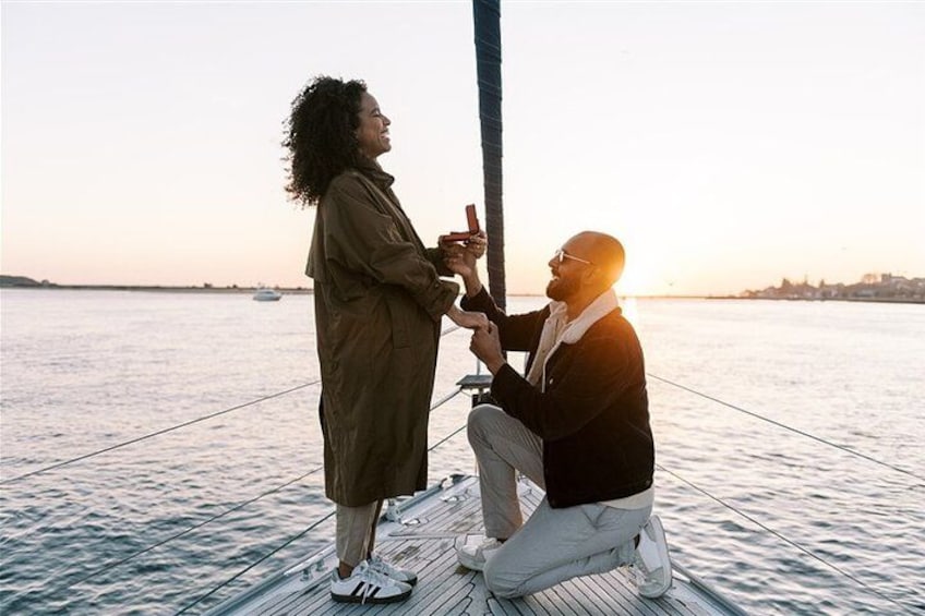 Two people on a dock by the water at sunset. 5