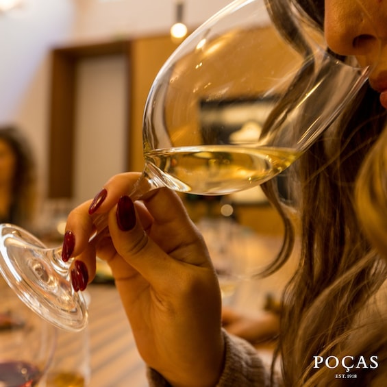 A person holding a wine glass. 2