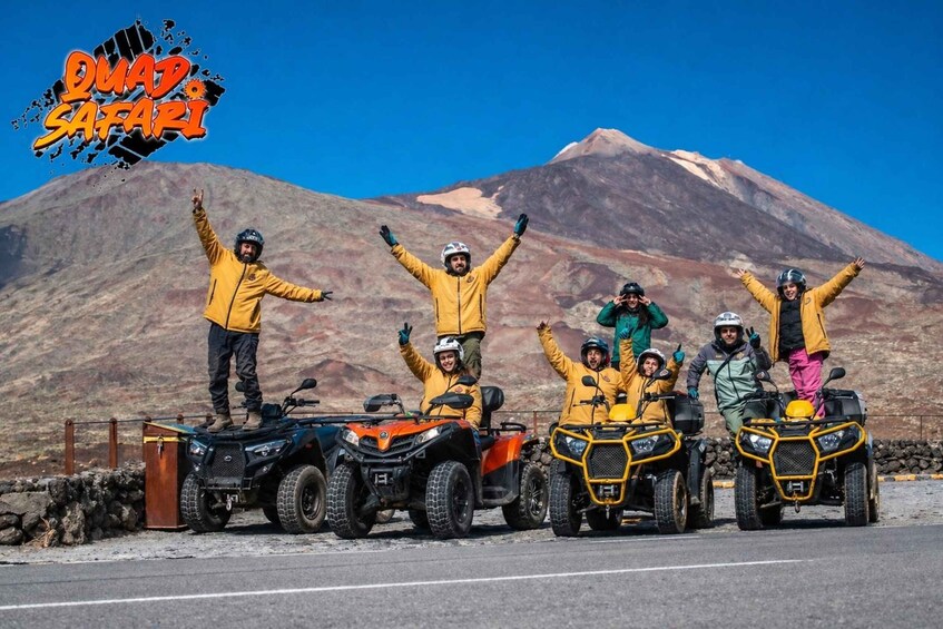 A group of people on all-terrain vehicles (ATVs) with a mountainous landscape in the background. 3