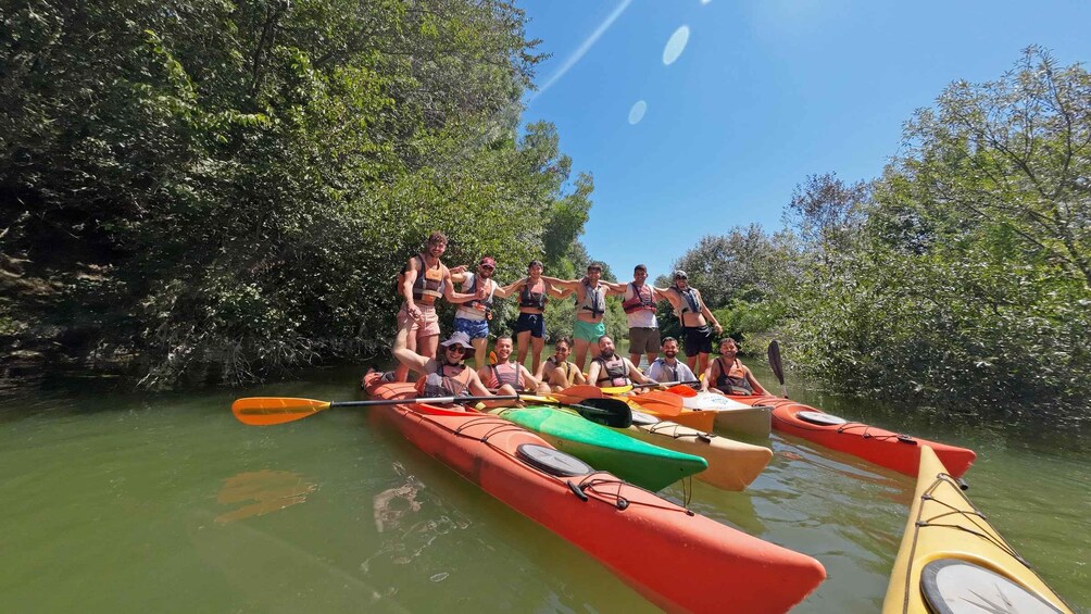 Un grupo de personas haciendo kayak en un río rodeado de vegetación densa. 1