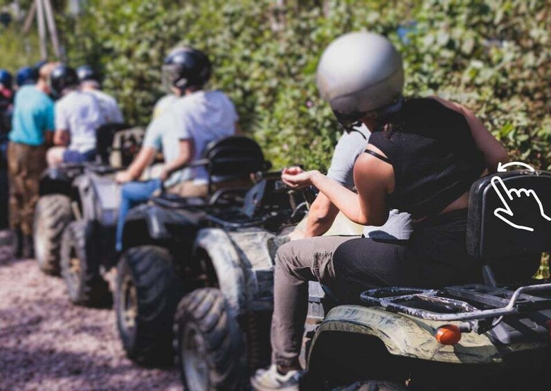 A group of people on ATVs in a forested area. 2