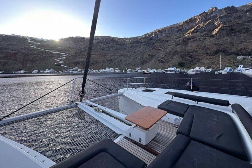 A boat deck with seating and a view of a coastal landscape with cliffs and a river. 3