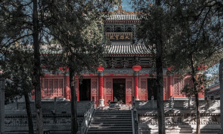 A traditional Chinese building with ornate architecture, red lanterns, and a staircase leading to the entrance. 2