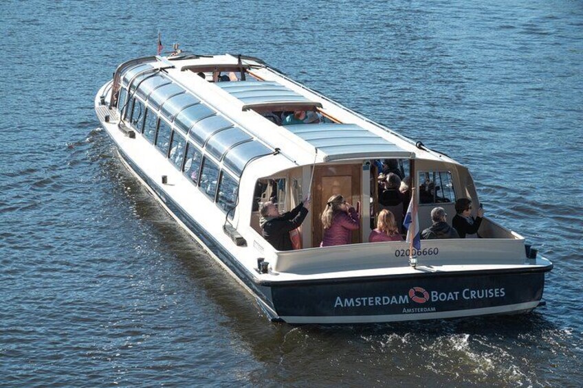 A boat with people on board, moving through water. 2