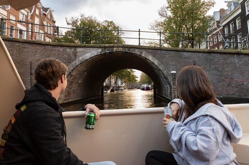 A canal with a bridge, a boat, and buildings in the background. 3