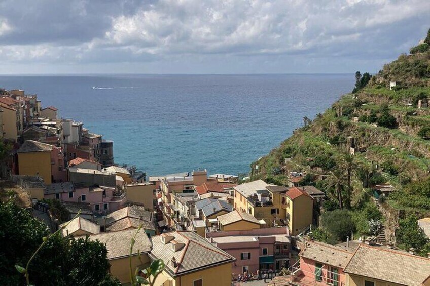 A coastal town with buildings along the hillside overlooking the sea. 4