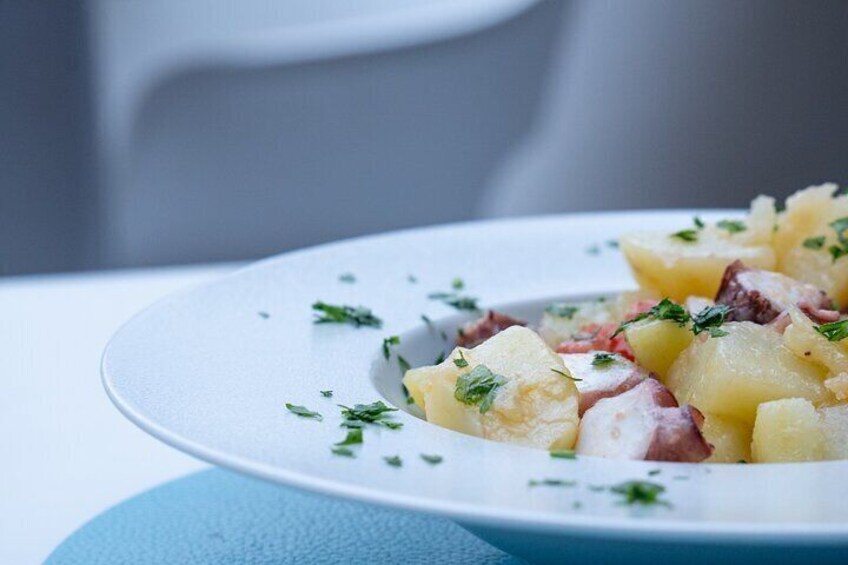 A plate of potato salad with herbs. 5