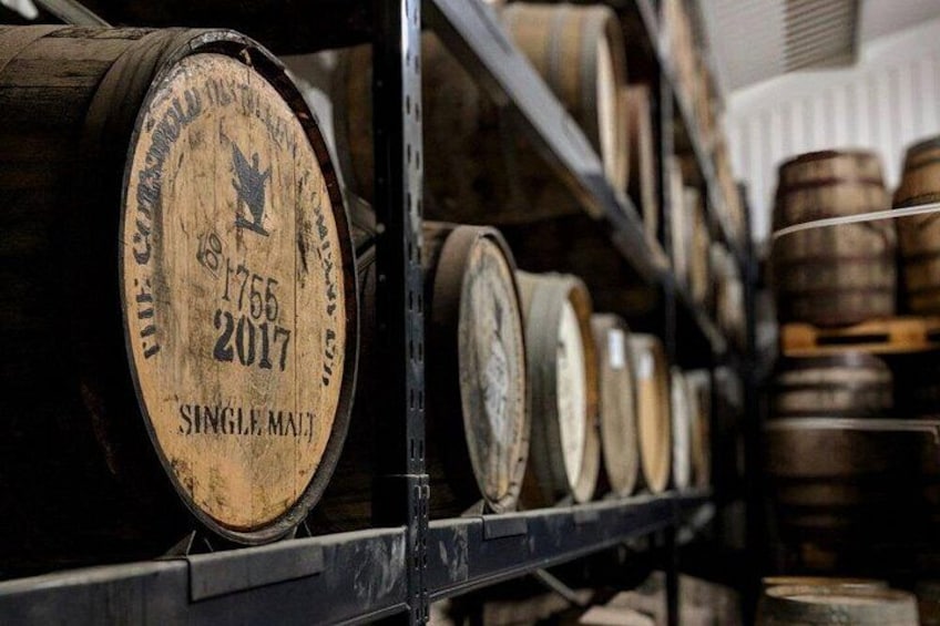 Wooden barrels on shelves in a storage area. 3