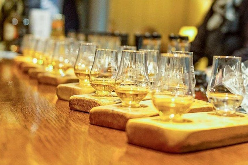 A row of empty wine glasses on wooden coasters. 2