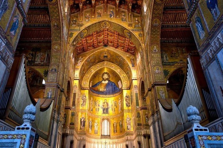 An ornate church interior with a central dome, golden mosaics, and detailed wall decorations. 3