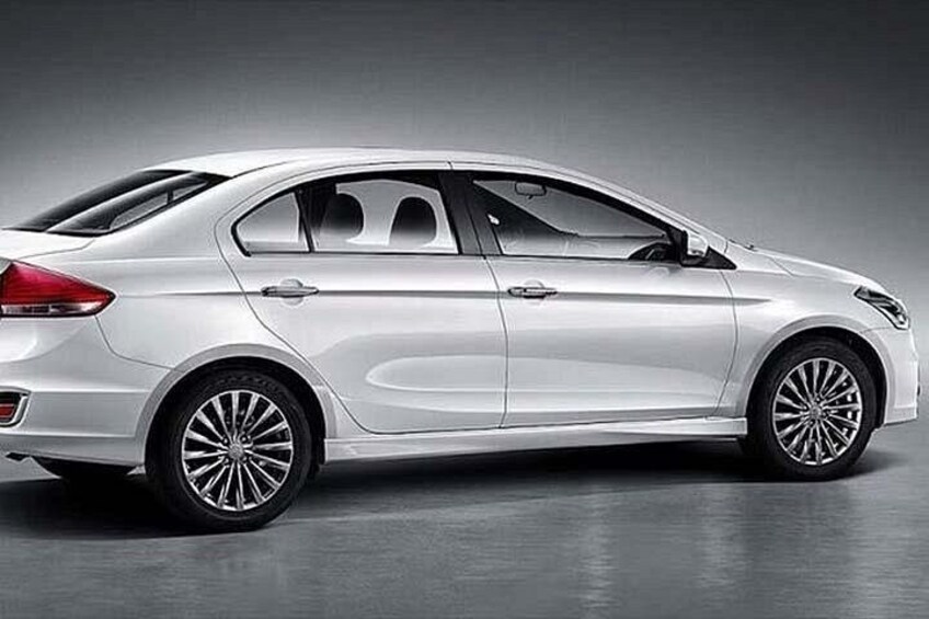 A white sedan with a sleek design, featuring alloy wheels and a streamlined body. 2