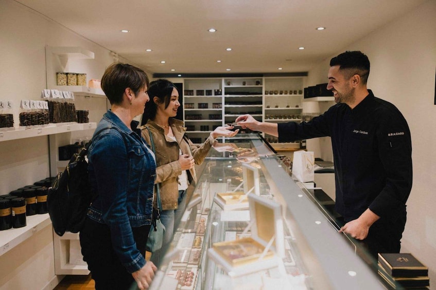 A jewelry store with a display case of items and shelves with boxes. 3