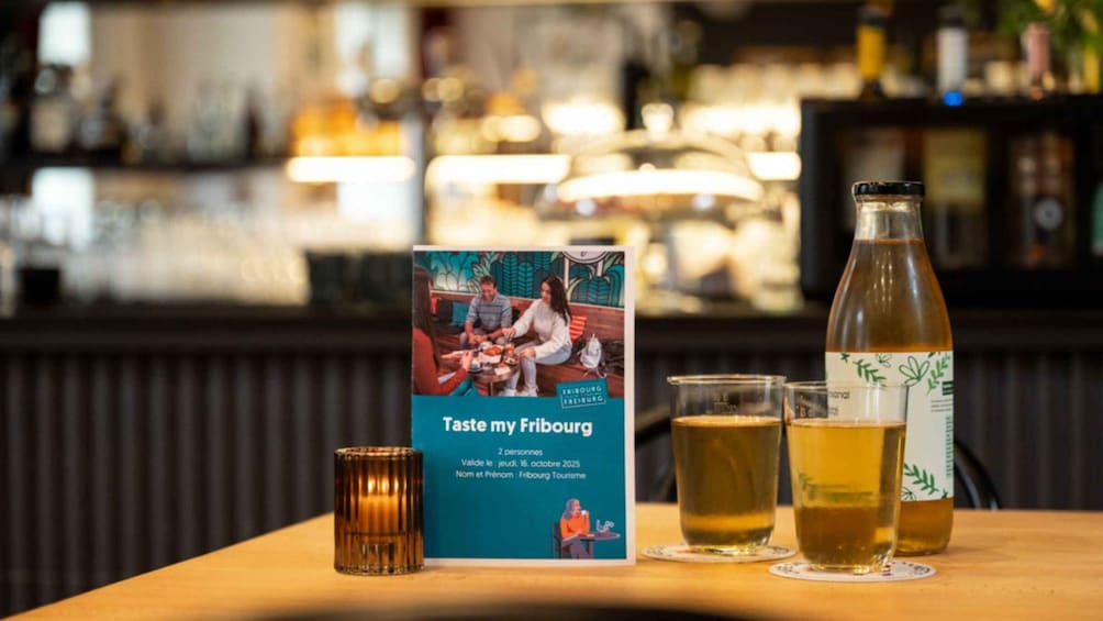A menu titled 'Taste my Fribourg' with a date and event name, a bottle of beer, and two glasses of beer on a table. 4