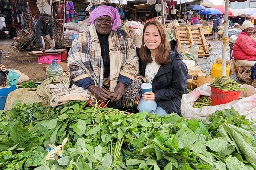 Interacting with local farmers market vendors at the local market tour. 1