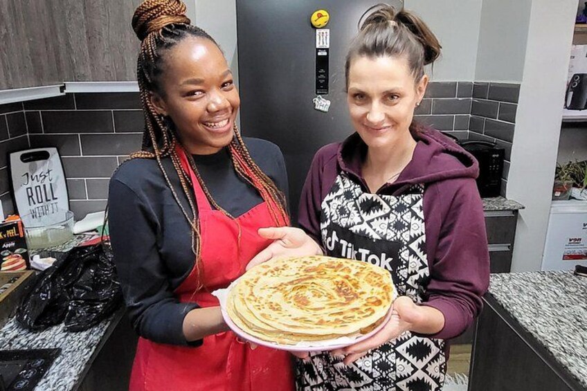 Guest showcasing what they made during the cooking class. 4