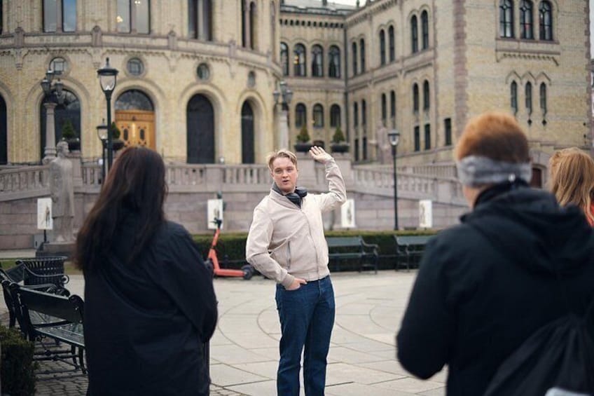 A person standing in a courtyard with a building in the background. 2