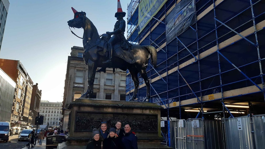 A statue of a horse and rider in front of a building under construction. 5