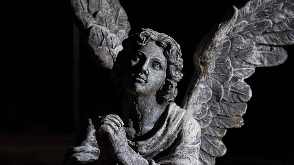 A statue of an angel with detailed wings and a serene expression. 1