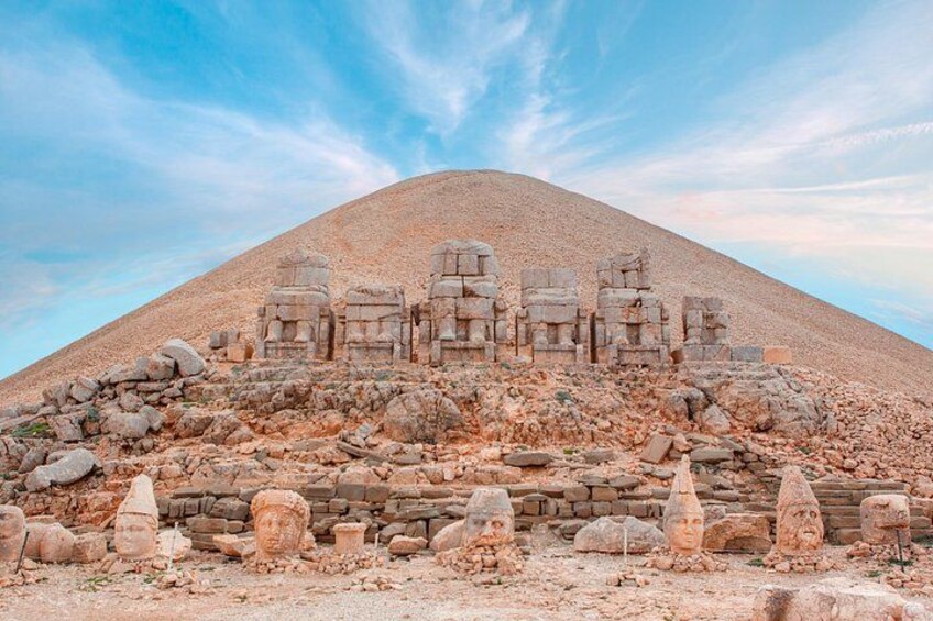 Ancient ruins on a hill with stone structures and columns. 3