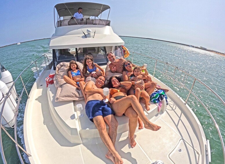 A group of people relaxing on a boat in the ocean. 1