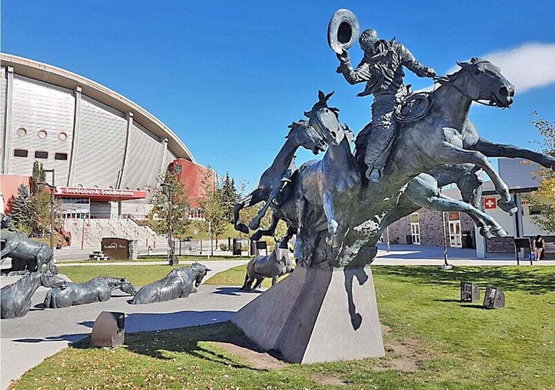 A sculpture of a man on a horse in a park. 3