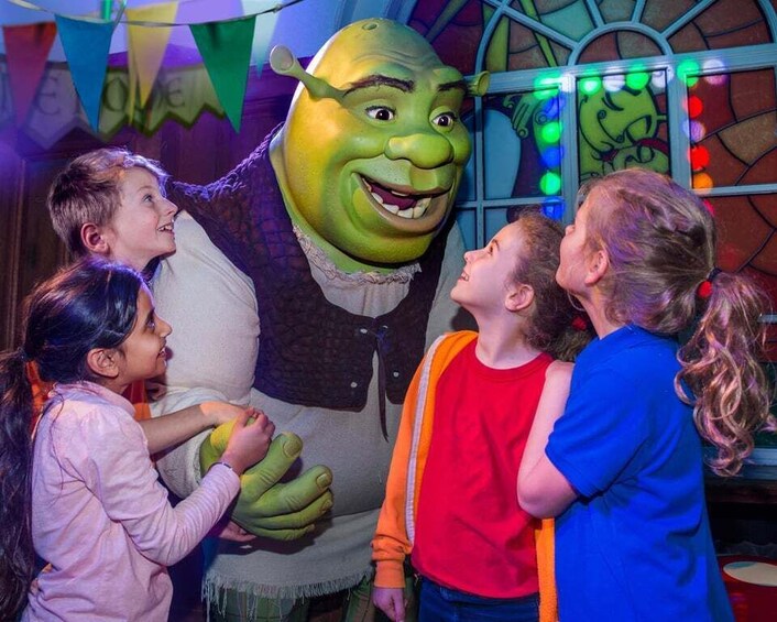 A character in a costume interacting with children. 4