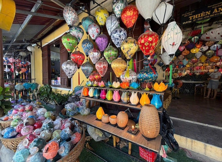 A variety of colorful lanterns and vases displayed in a market stall. 5