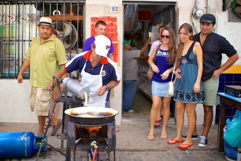 A street vendor cooking food on a portable stove. 4