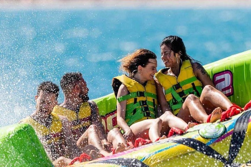 People on an inflatable raft with water splashing around them. 5
