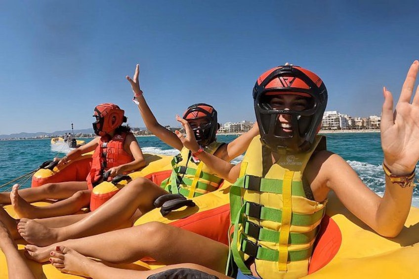 People on a watercraft wearing life jackets and helmets. 4