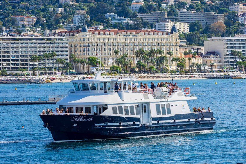 A boat named 'Silhouette' on a body of water with a cityscape in the background. 3
