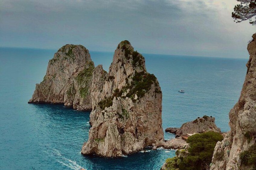 A coastal landscape with rocky cliffs and a clear blue sea. 5