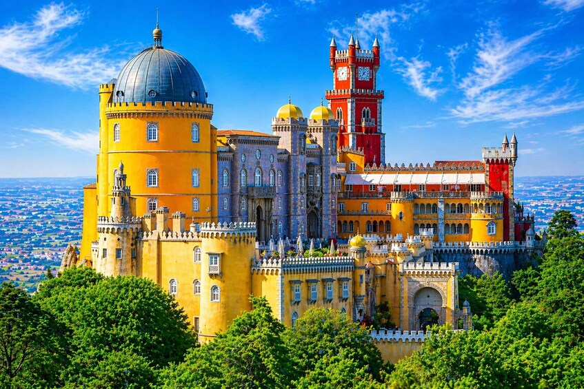 A historic castle with yellow and red walls, a prominent clock tower, and a dome. 1