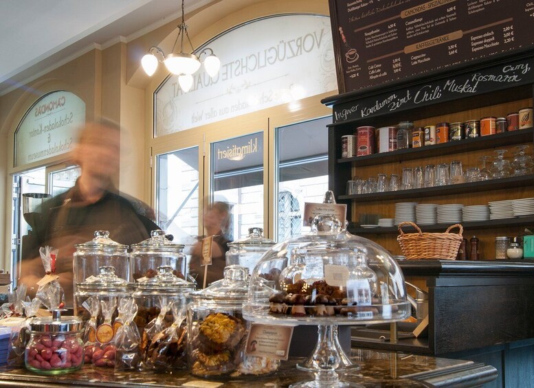 A bakery display with various pastries and a menu board in the background. 4