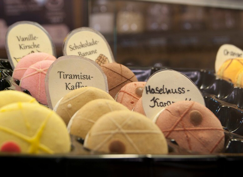 A display of various ice cream flavors with labels in a store. 5