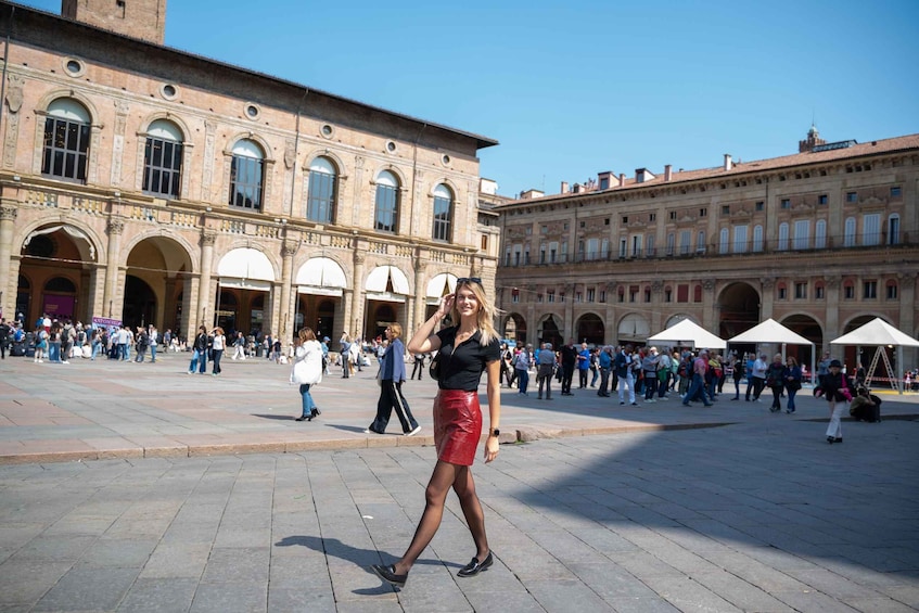 A historic square with people walking, a woman in a red skirt, and classical architecture. 3