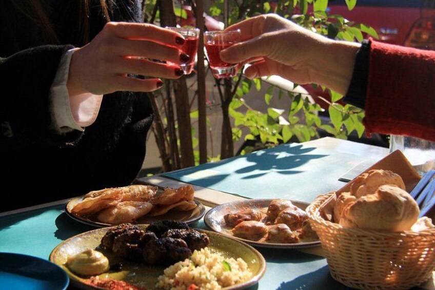 sitting around the table and sharing meze food 3