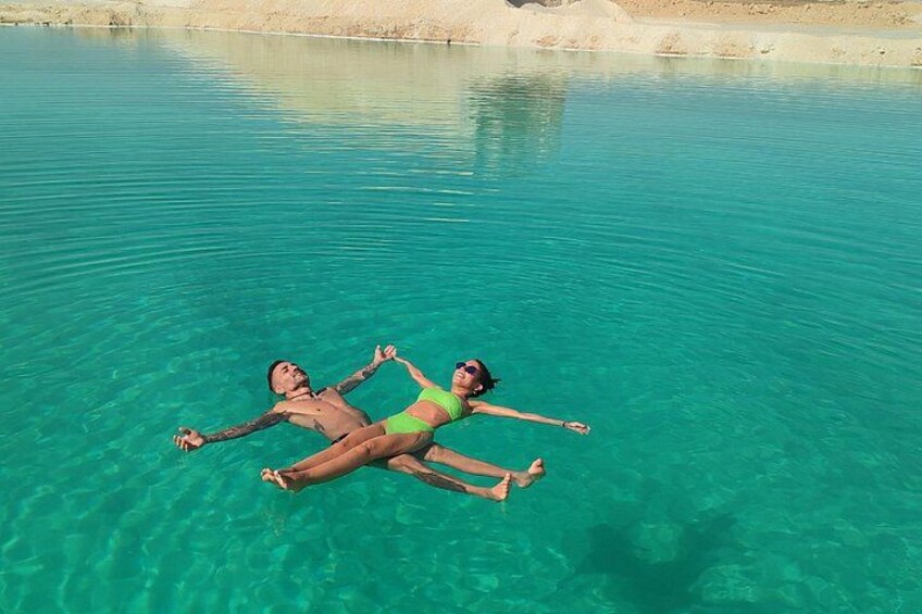 Two people floating in clear turquoise water. 5