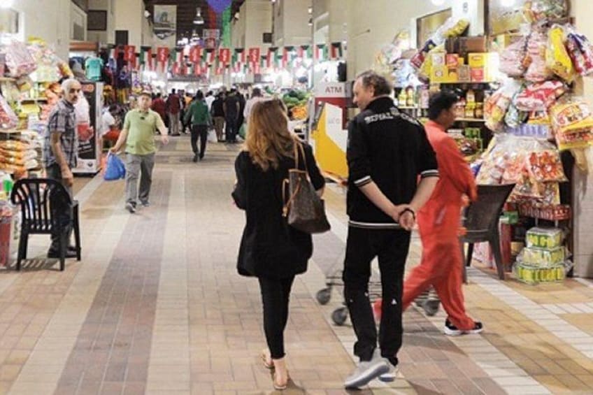 A busy indoor market with shoppers and vendors. 3