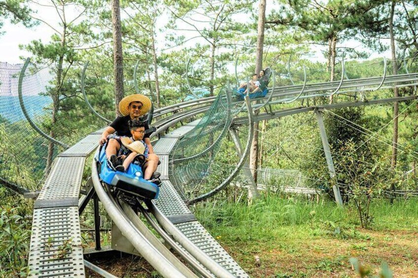 A roller coaster with a track winding through a forested area. 4