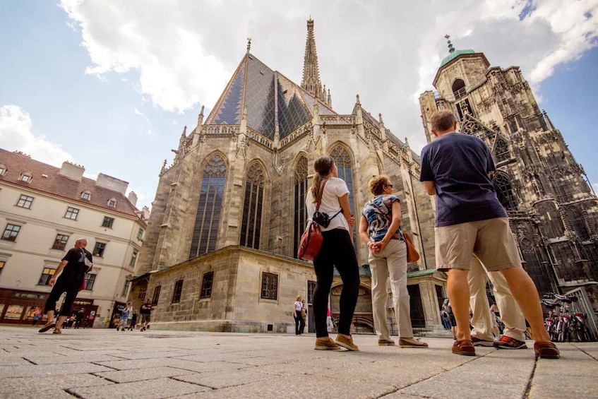 A historic cathedral with Gothic architecture, a prominent spire, and a large rose window. 2