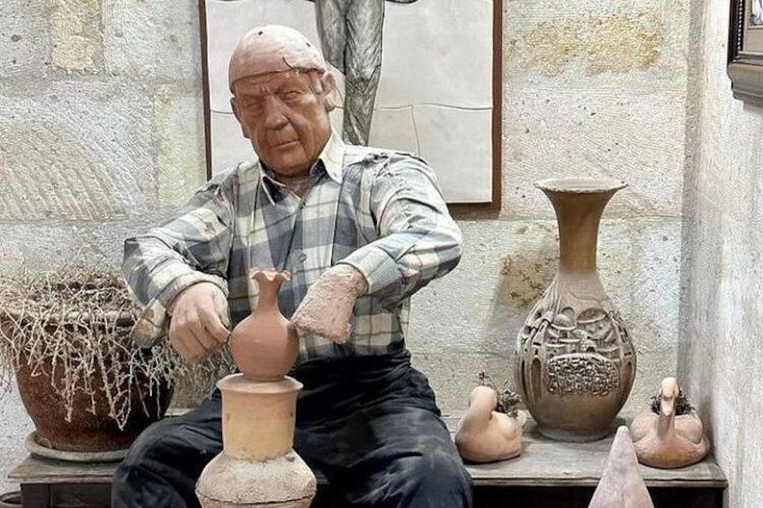 An elderly man sculpting a clay pot. 1