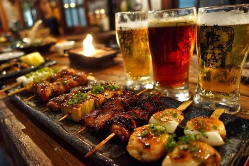 Skewers of grilled meat and vegetables, a candle, and glasses of beer on a wooden table. 5