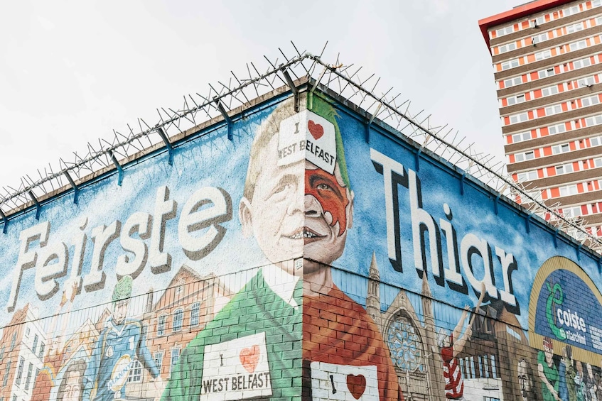 A mural on a building with a mix of colors and text, including 'Fairste' and 'Thiar'. 1