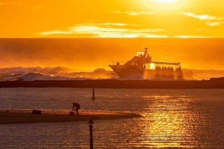 A boat on a body of water during sunset. 2