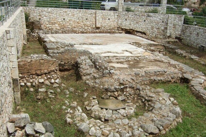 Ancient ruins with stone walls and a circular structure. 2