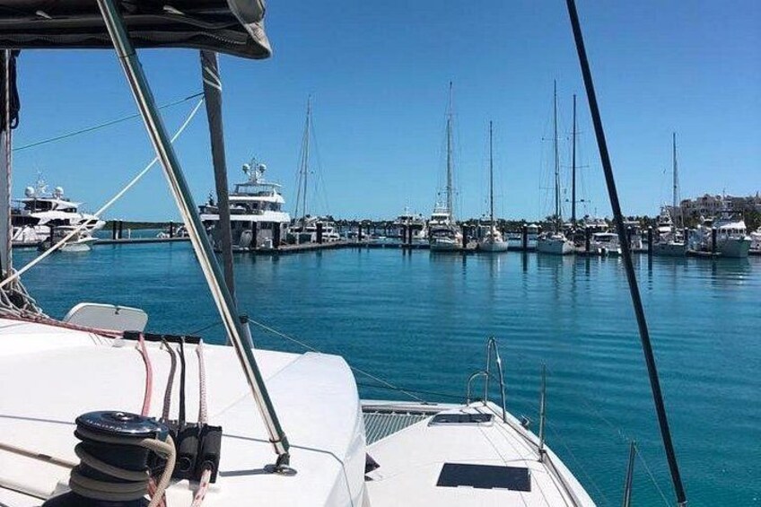 A marina with multiple sailboats docked. 4
