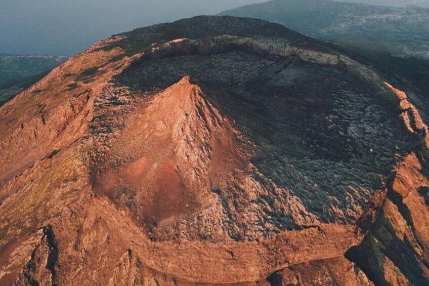 A large, circular, reddish-brown crater with steep walls. 1